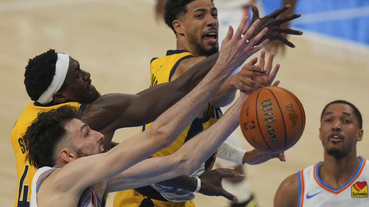 Indiana Pacers forward Pascal Siakam, Oklahoma City Thunder forward Chet Holmgren, left, and Indiana Pacers guard Tyrese Haliburton, center, battle for the rebound during the second half of Game 5 of the NBA Finals basketball series, Monday, June 16, 2025, in Oklahoma City.