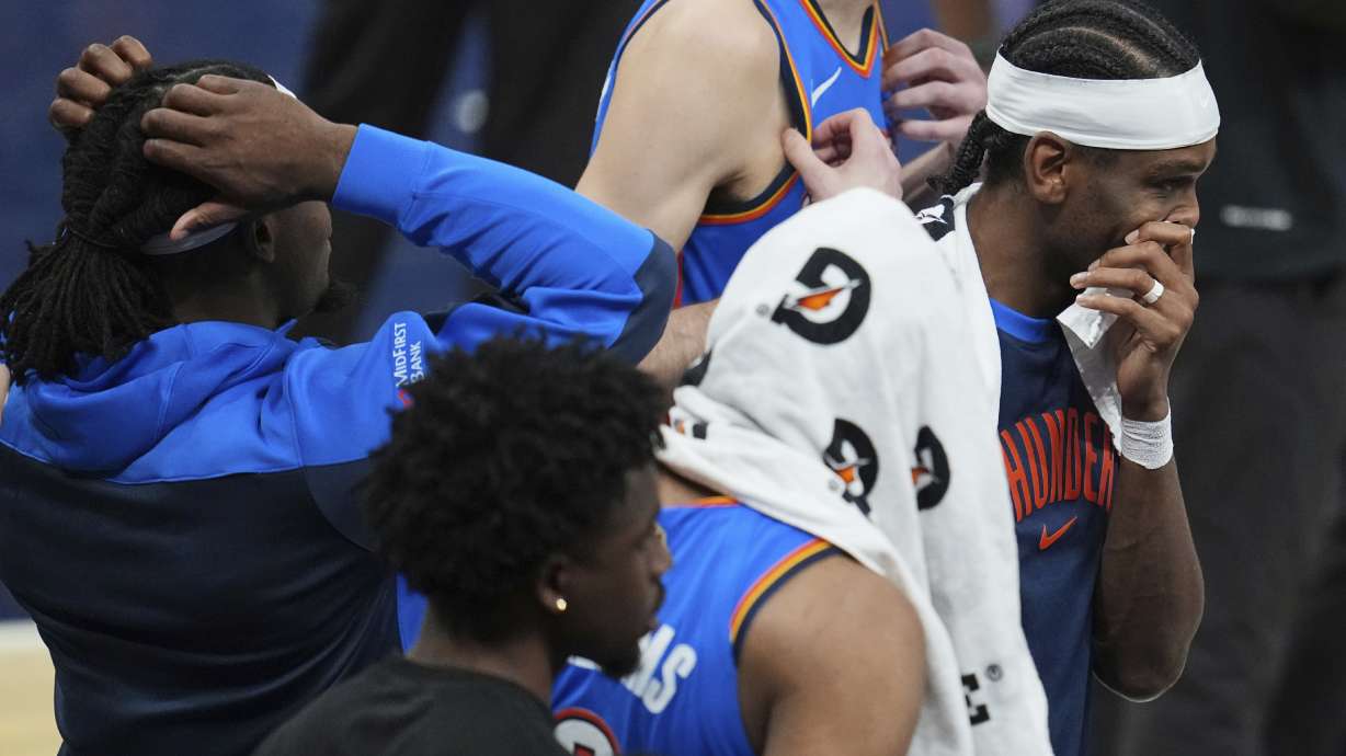 Oklahoma City Thunder guard Shai Gilgeous-Alexander, right, stands with teammates during a timeout during the second half of Game 6 of the NBA Finals basketball series against the Indiana Pacers, Thursday, June 19, 2025, in Indianapolis.