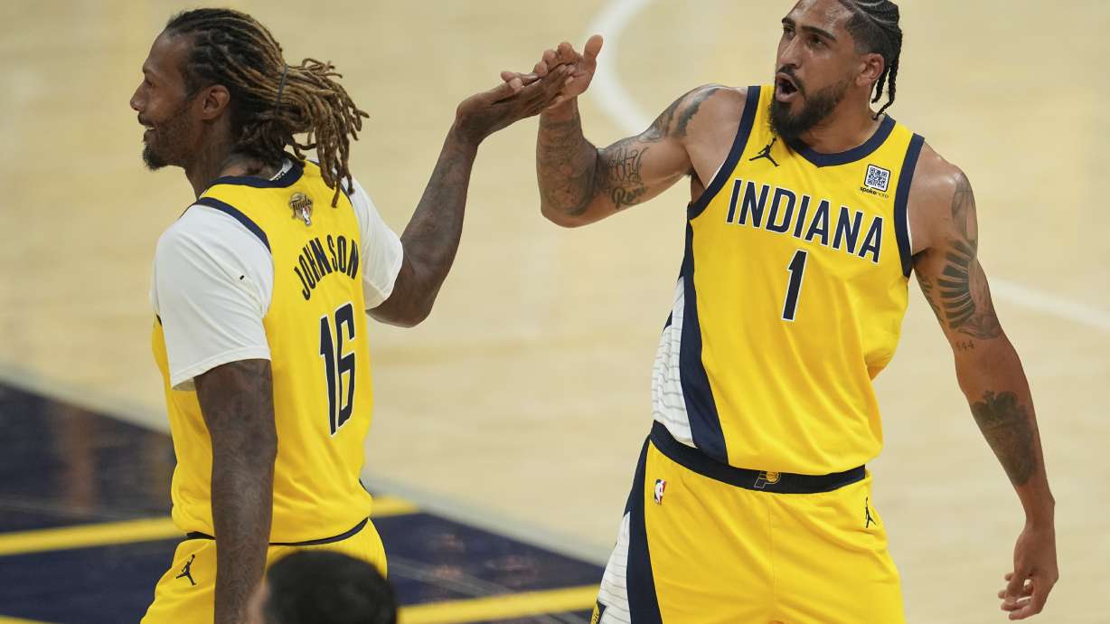 Indiana Pacers forward Obi Toppin (1) celebrates with forward James Johnson (16) during the second half of Game 6 of the NBA Finals basketball series against the Oklahoma City Thunder, Thursday, June 19, 2025, in Indianapolis.