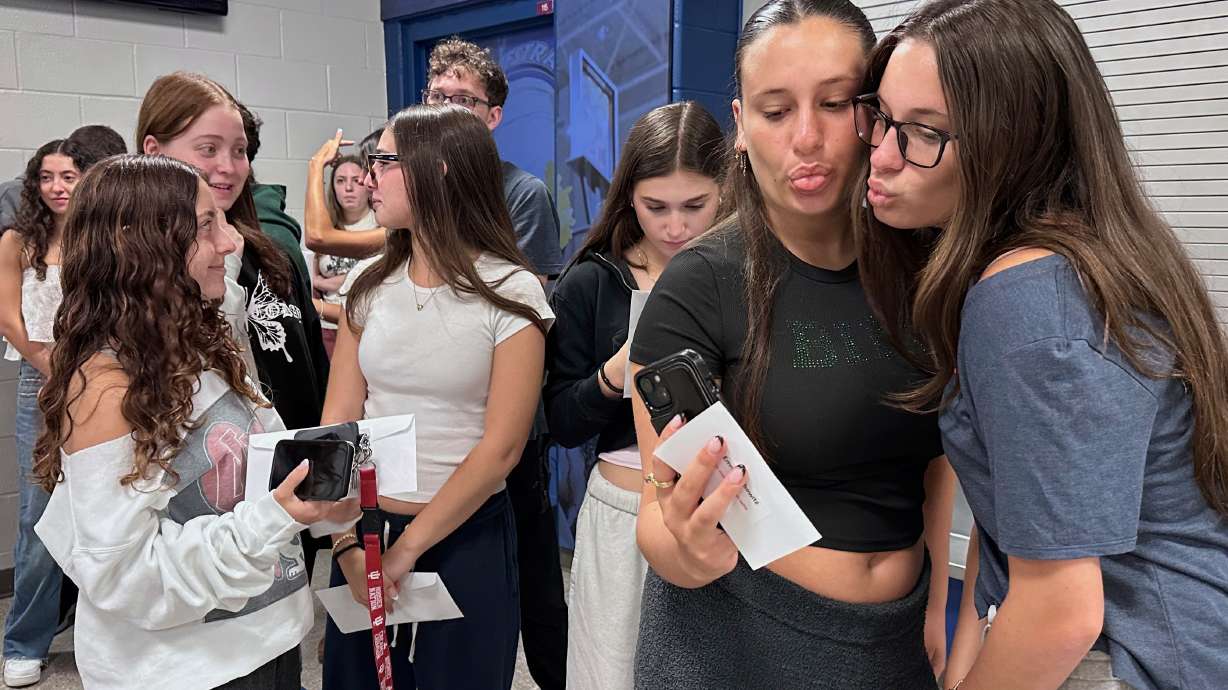 Twin sisters Emma Leibowitz, left, and Kayla Leibowitz attend rehearsal for Plainview-Old Bethpage John F. Kennedy High School's graduation ceremony at Hofstra University in Hempstead, N.Y., on Tuesday.