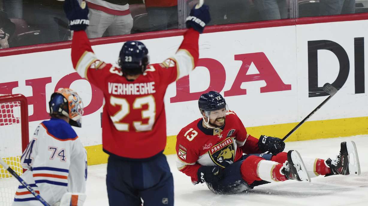 Florida Panthers' Sam Reinhart (13) celebrates his goal against Edmonton Oilers goalie Stuart Skinner (74) as Panthers' Carter Verhaeghe (23) reacts during the first period in Game 6 of the NHL hockey Stanley Cup Final in Sunrise, Fla., Tuesday, June 17, 2025.