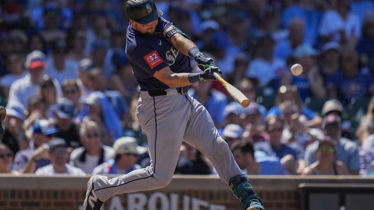 Seattle Mariners' Cal Raleigh hits a two-run home run during the seventh inning of a baseball game against the Chicago Cubs, Friday, June 20, 2025, in Chicago.