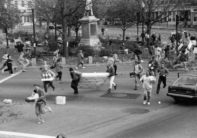 Local extras stampede through Central Square during a looting scene shot during the filming of Jumanji on Nov. 17, 1994 in Keene, N.H.