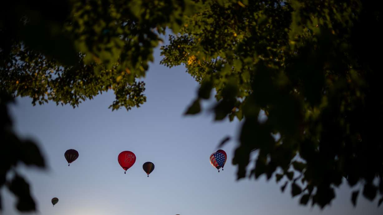 Hot air balloons take to the sky during the Sandy Balloon Festival at Storm Mountain Park in Sandy on Aug. 14, 2021. A hot-air balloon has caught fire and tumbled from the sky in Brazil's southern state of Santa Catarina, killing eight people.