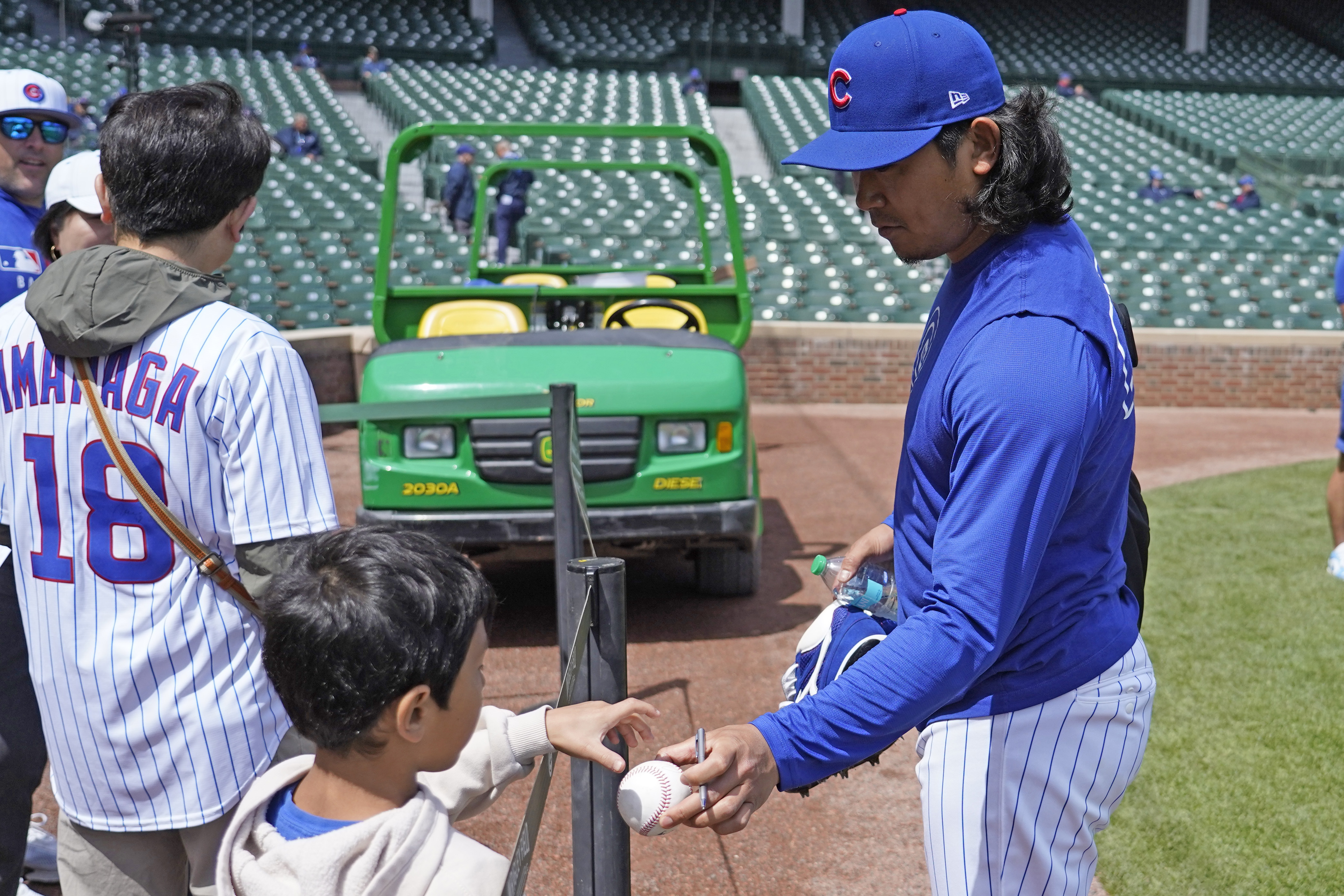 Chicago Cubs pitcher Shota Imanaga signs autographs before a baseball game against the Colorado Rockies Monday, May 26, 2025, in Chicago.