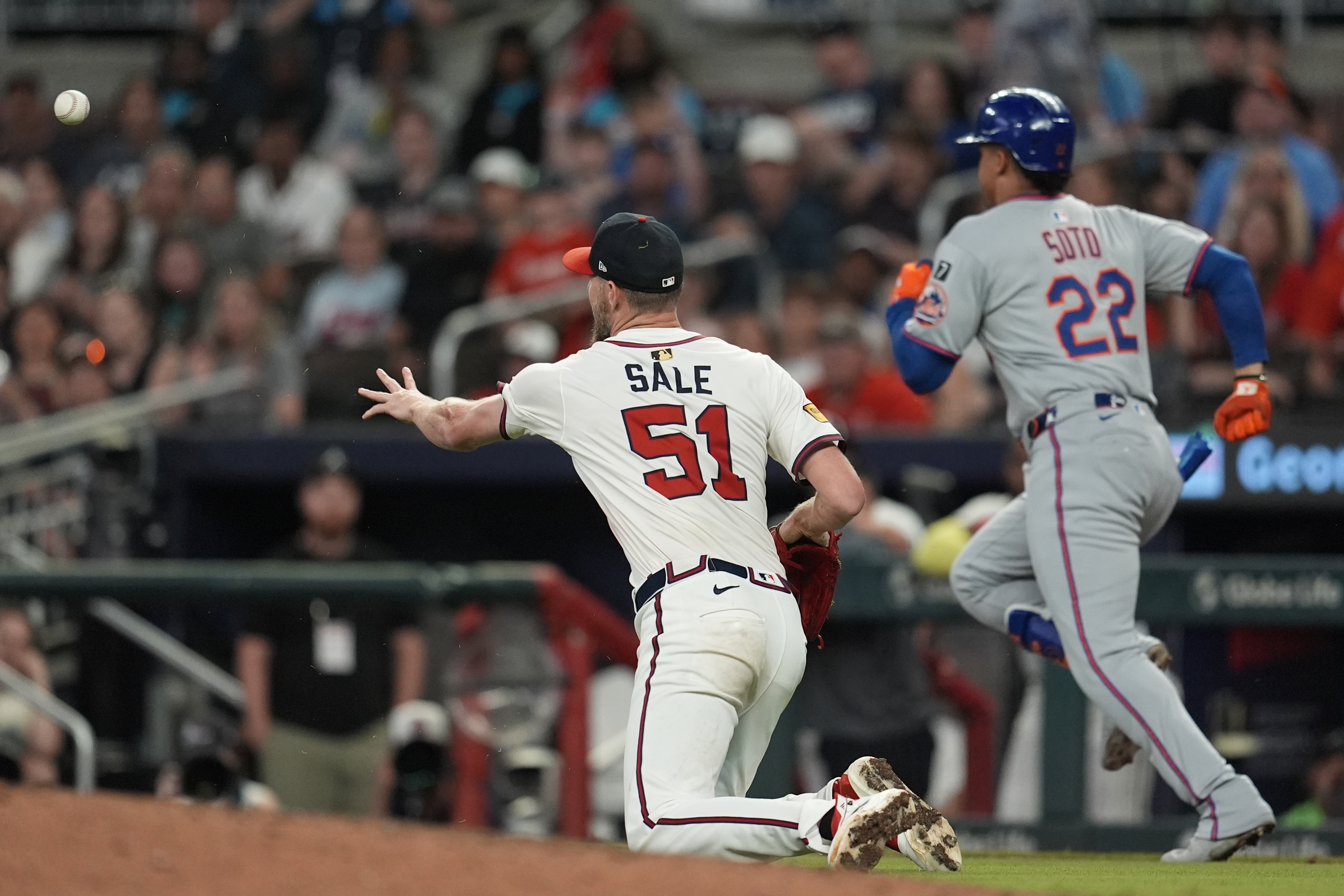Atlanta Braves pitcher Chris Sale (51) fields a ball hit by New York Mets' Juan Soto (22) in the ninth inning of a baseball game, Wednesday, June 18, 2025, in Atlanta.