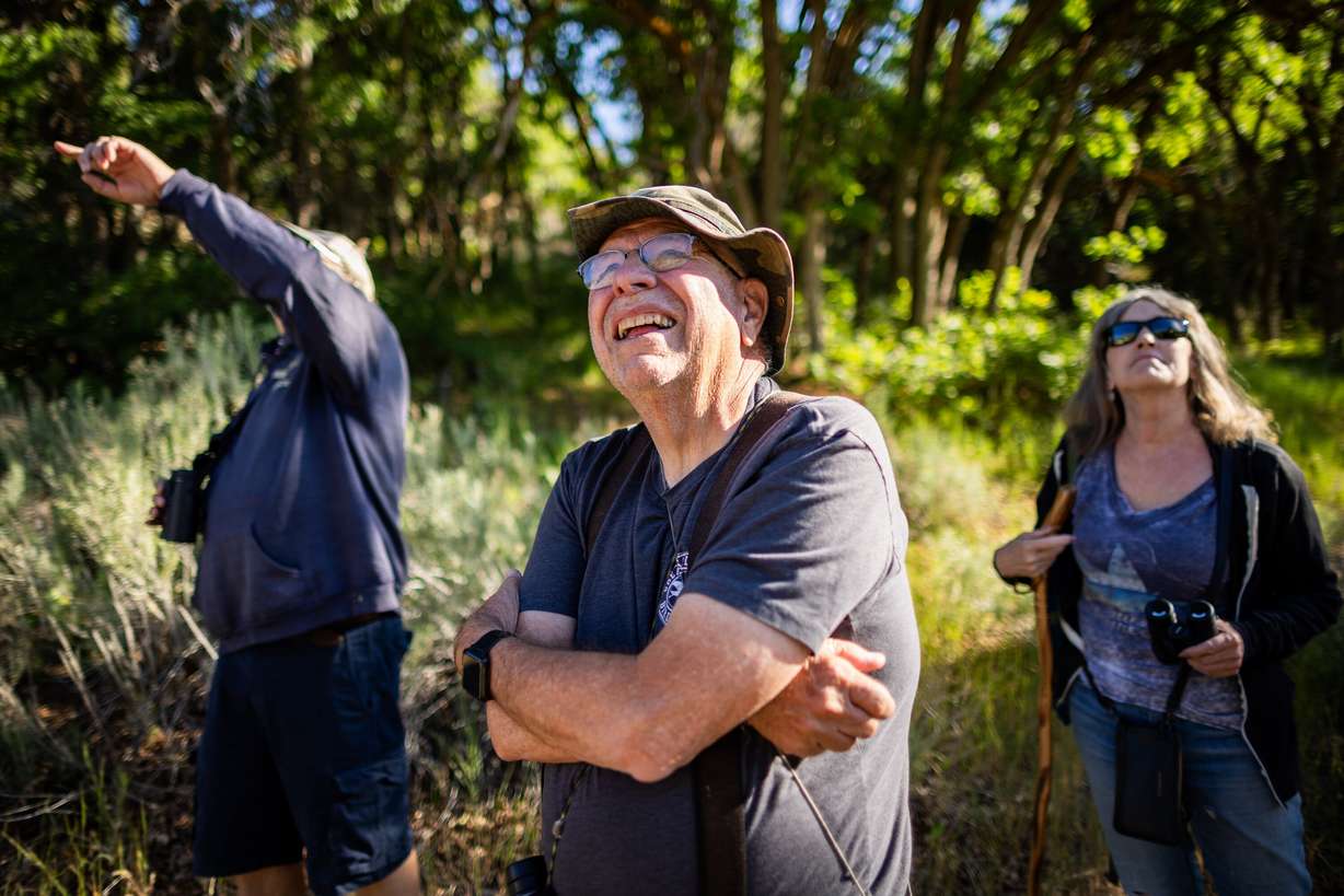 Neldon Kunz, center, looks for birds during a Great Salt Lake Audubon Society bird walk at Yellow Fork Canyon in Herriman on June 8.