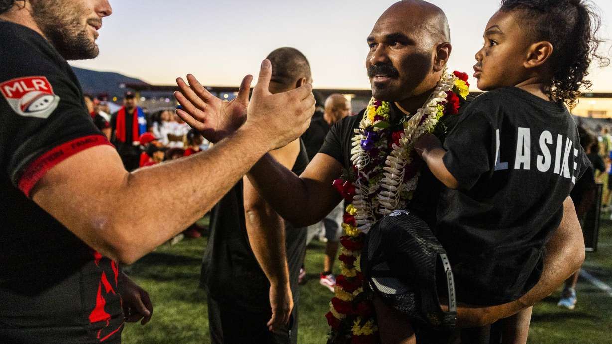 Paul Lasike shakes hands with a fellow Utah Warriors player after a ceremony honoring Lasike’s career and retirement after a Utah Warriors Major League Rugby game against RFC Los Angeles at Zions Bank Stadium in Herriman on Saturday, June 7, 2025. Lasike is retiring from professional rugby after a career that has taken him to BYU to play college football, the NFL, England and around the world with the USA Eagles national team.
