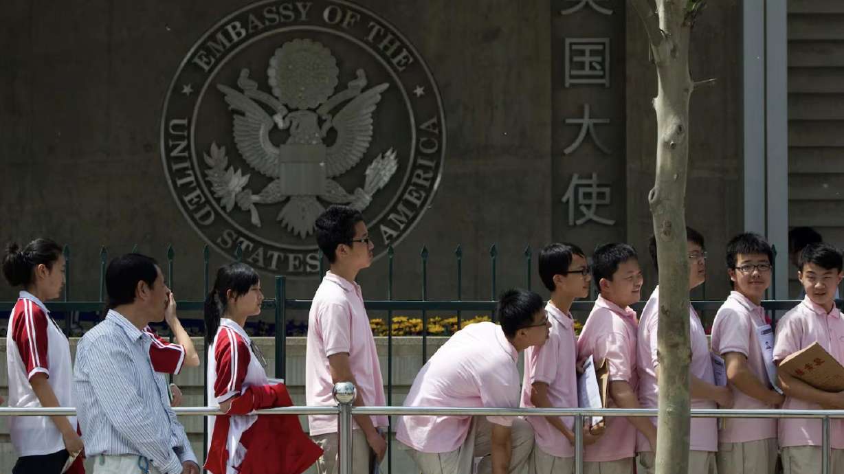 Chinese students wait outside the U.S. Embassy for their visa application interviews, in Beijing on May 2, 2012. Following a recent halt, the State Department will resume new visa interviews for foreign students — but with enhanced vetting.