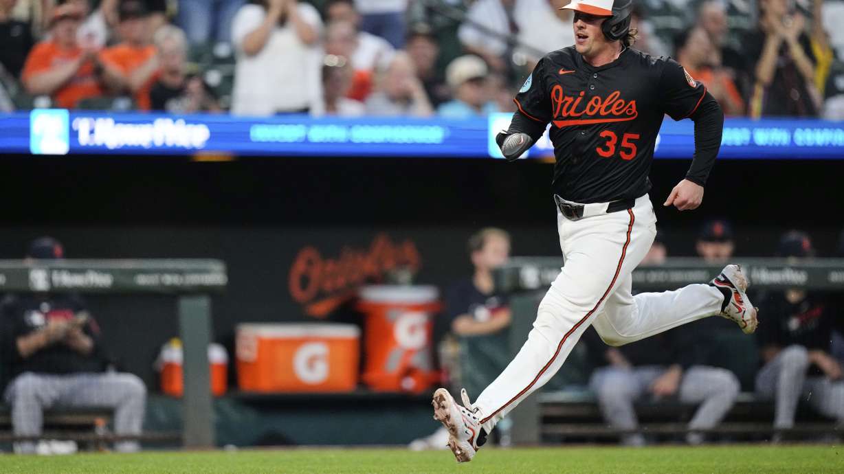 Baltimore Orioles' Adley Rutschman (35) advances toward home plate to score on an RBI hit in by Gunnar Henderson during the seventh inning of a baseball game against the Detroit Tigers, Wednesday, June 11, 2025, in Baltimore.