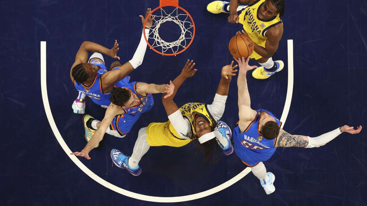 Indiana Pacers center Myles Turner (33) drives to the basket against Oklahoma City Thunder forward Chet Holmgren (7) during the first half of Game 6 of the NBA Finals basketball series, Thursday, June 19, 2025, in Indianapolis.