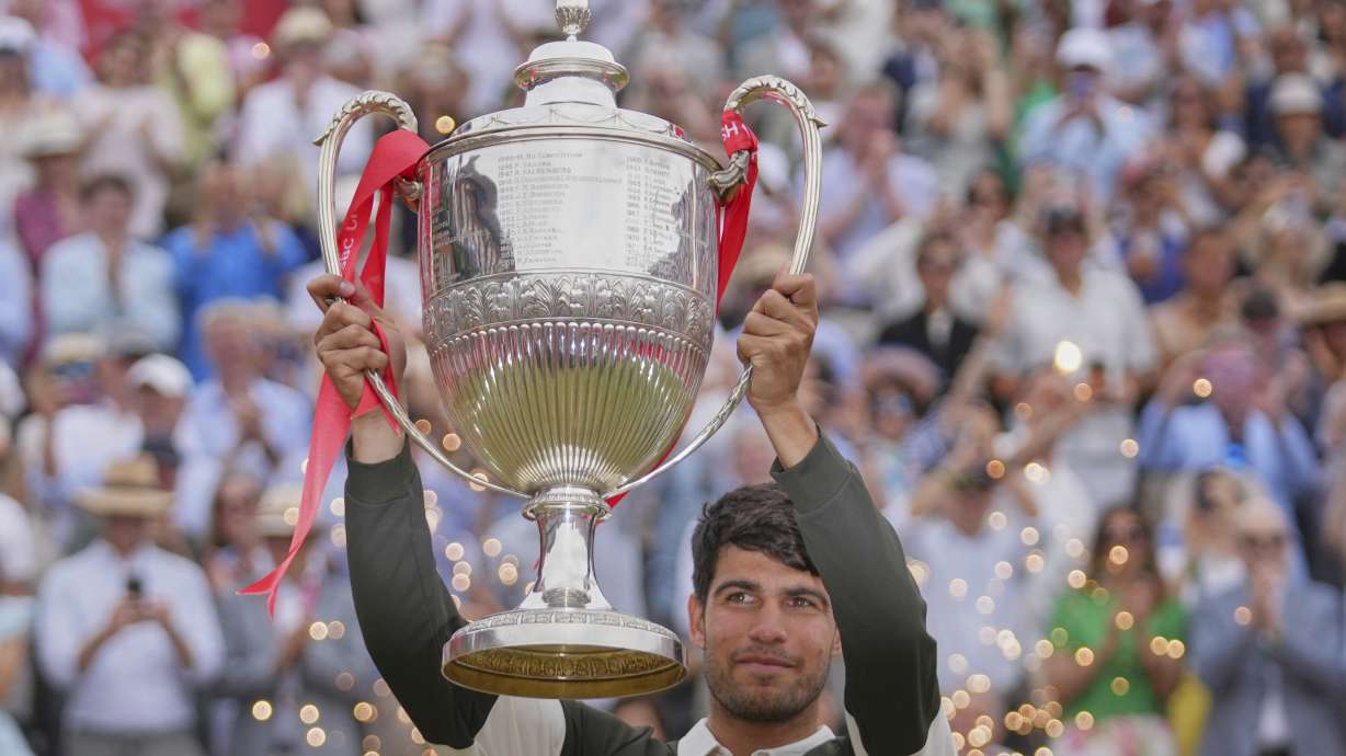 Carlos Alcaraz of Spain told up the winners trophy after defeating Jiri Lehecka of the Czech Republic, in the men's singles final of the Queens Club tennis championships in London, Sunday, June 22, 2025.