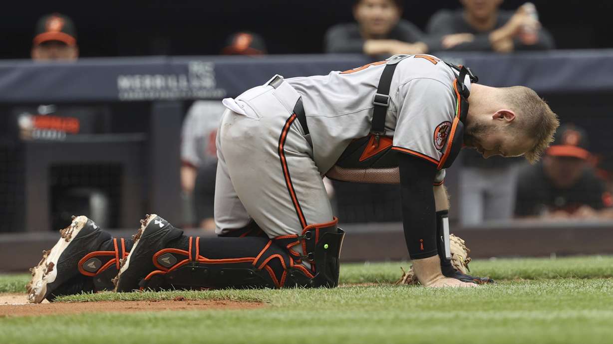 Baltimore Orioles catcher Maverick Handley reacts after colliding with New York Yankees' Jazz Chisholm Jr. during the second inning of a baseball game Sunday, June 22, 2025, in New York.