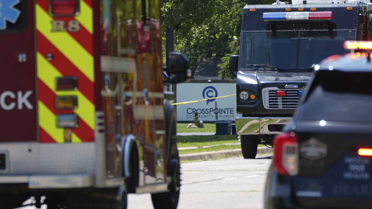 Emergency vehicles gather near CrossPointe Community Church in Wayne, Mich., Sunday. A Michigan police chief says church staff fatally shot a man armed with a handgun and a long gun, averting a potential mass shooting