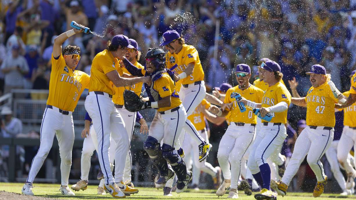 LSU players celebrate the defeating Coastal Carolina in Game 2 of the NCAA College World Series baseball finals in Omaha, Neb., Sunday, June 22, 2025.