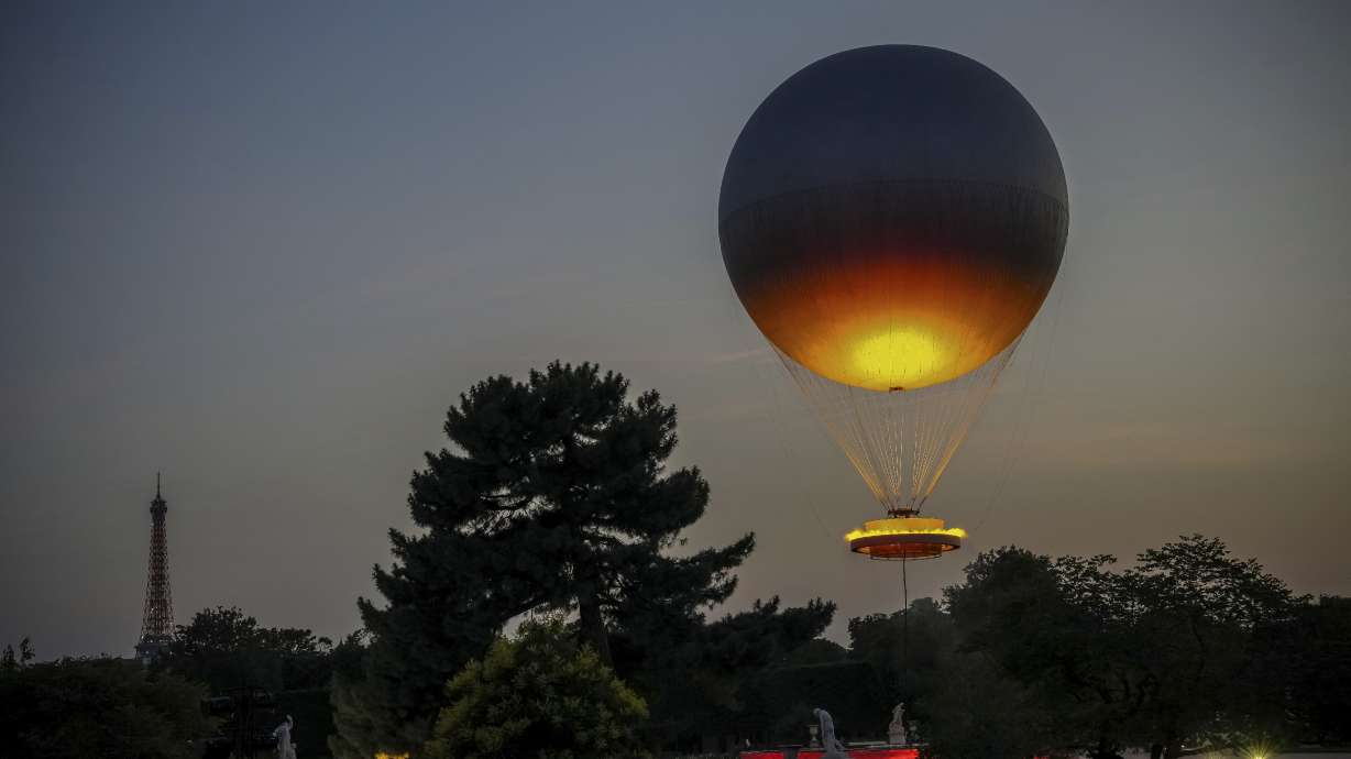 The helium ballon that was used during the 2024 Olympic Games as the Olympic cauldron is launched in the Tuileries Gardens of Paris on Saturday, June 21, 2025, with the Eiffel Tower in the background.
