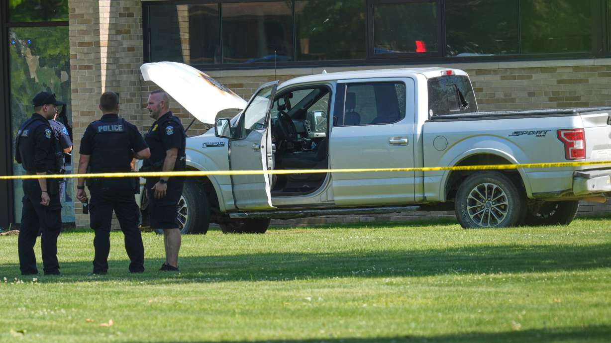 Police at the CrossPointe Community Church in Wayne, Mich., on Sunday. They say a man who opened fire outside the church had attended services there a couple of times and his mother is a member.