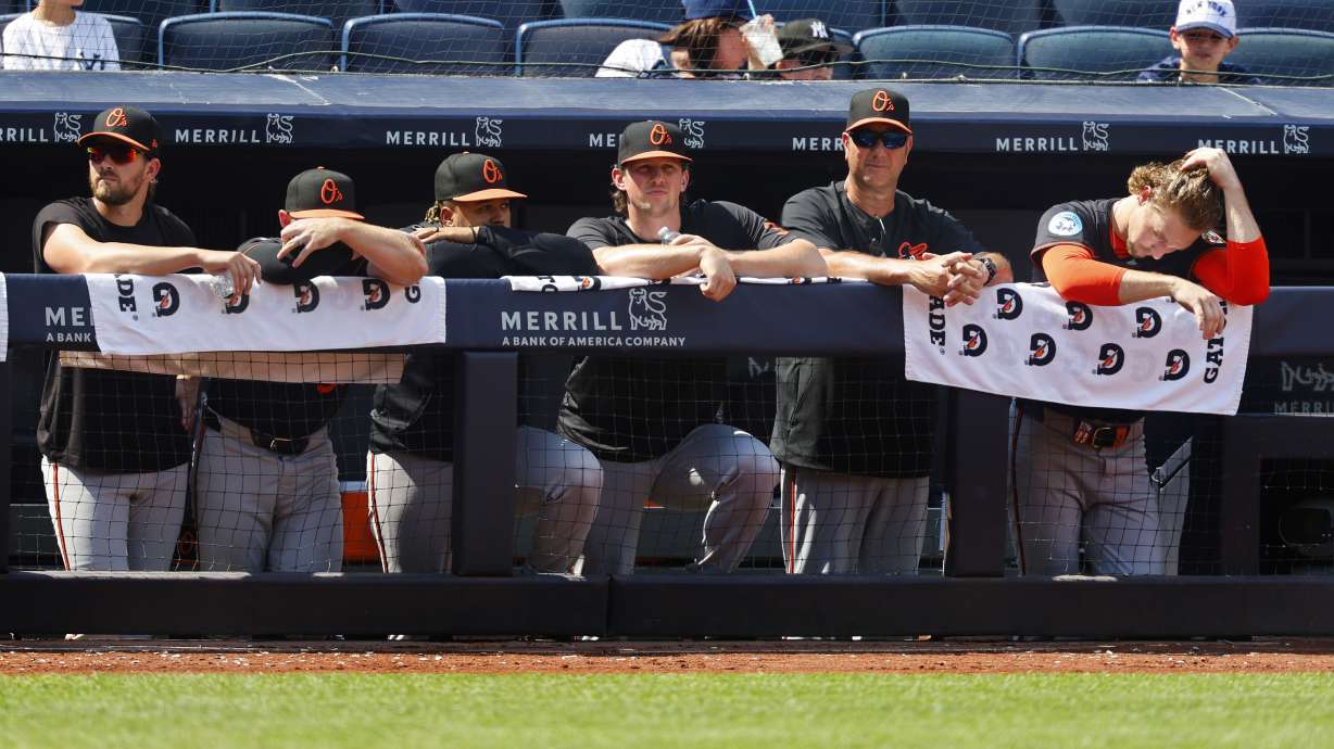 Baltimore Orioles players watch from the dugout railing during the seventh inning of a baseball game against the New York Yankees, Saturday, June 21, 2025, in New York.