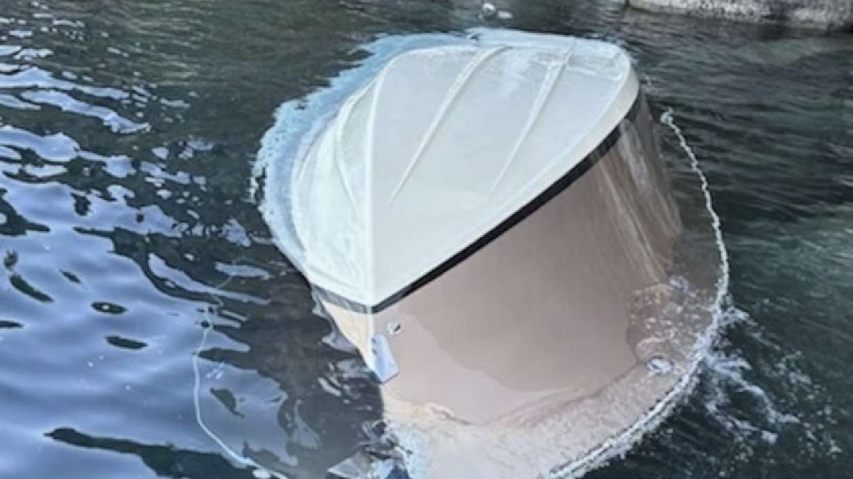 A capsized vessel floats near D.L. Bliss State Park at Lake Tahoe, Calif., Saturday. Six people were confirmed dead and two others were missing after a boat capsized on Lake Tahoe in California during a powerful weekend thunderstorm.