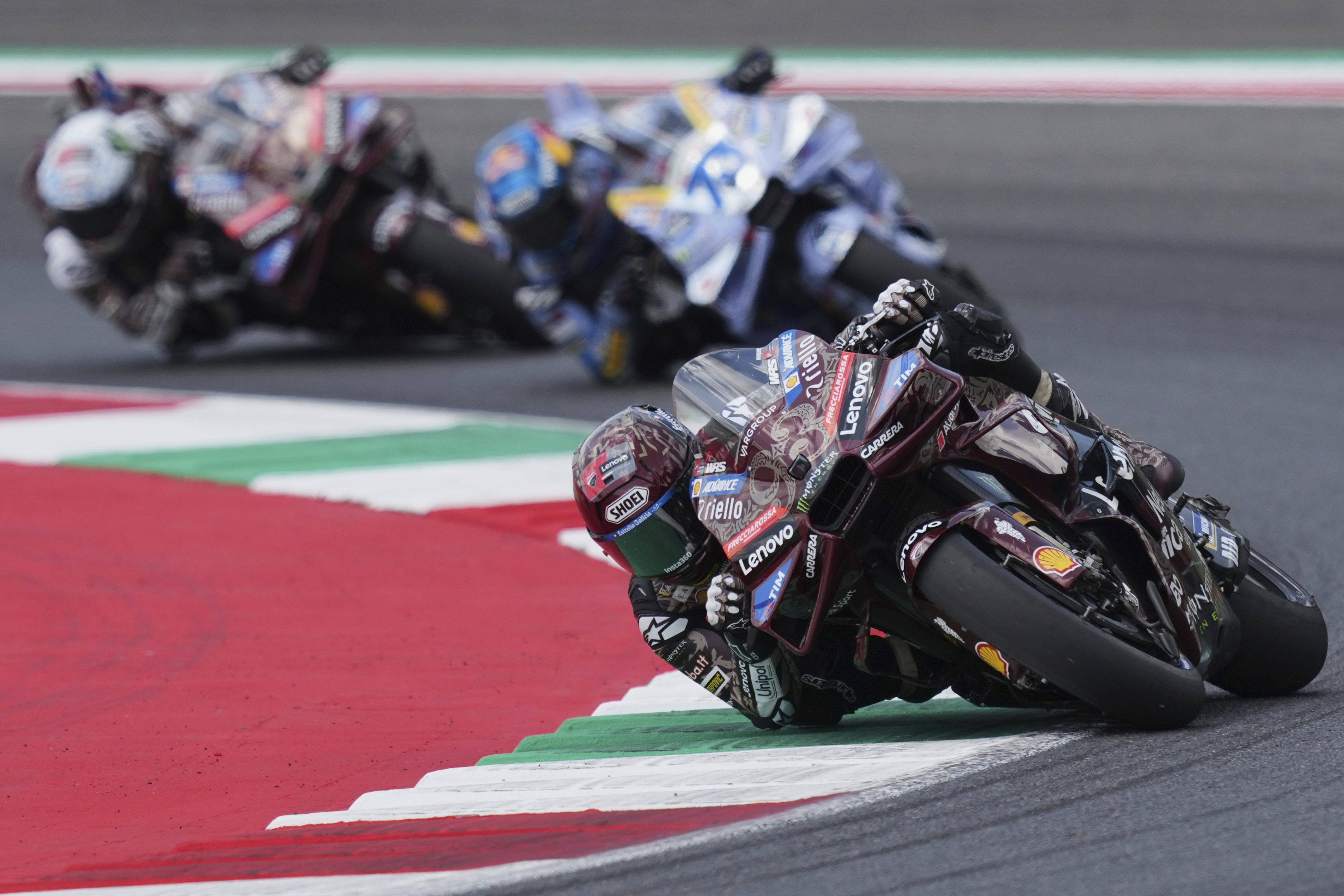 Spain's rider Marc Marquez of the Ducati Lenovo Team steers his motorcycle followed by Spain's rider Alex Marquez of the BK8 Gresini Racing MotoGP and Italian rider Francesco Bagnaia of the Ducati Lenovo Team during the MotoGP race of the Grand Prix of Italy at the Mugello circuit in Scarperia, Italy, Sunday, June 22, 2025.