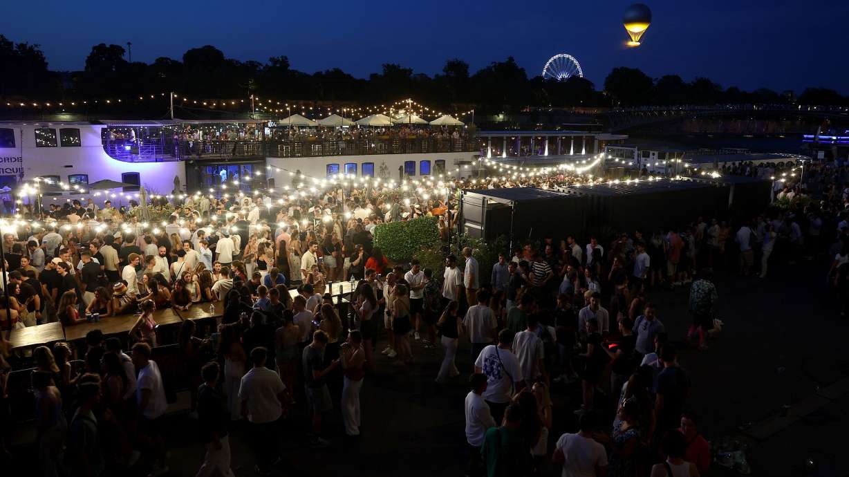 People attend France's annual street music festival, the Fête de la Musique, on the Seine river banks in Paris on Saturday. Nearly 150 people in France reported being pricked with syringes during the street music festival at the weekend.