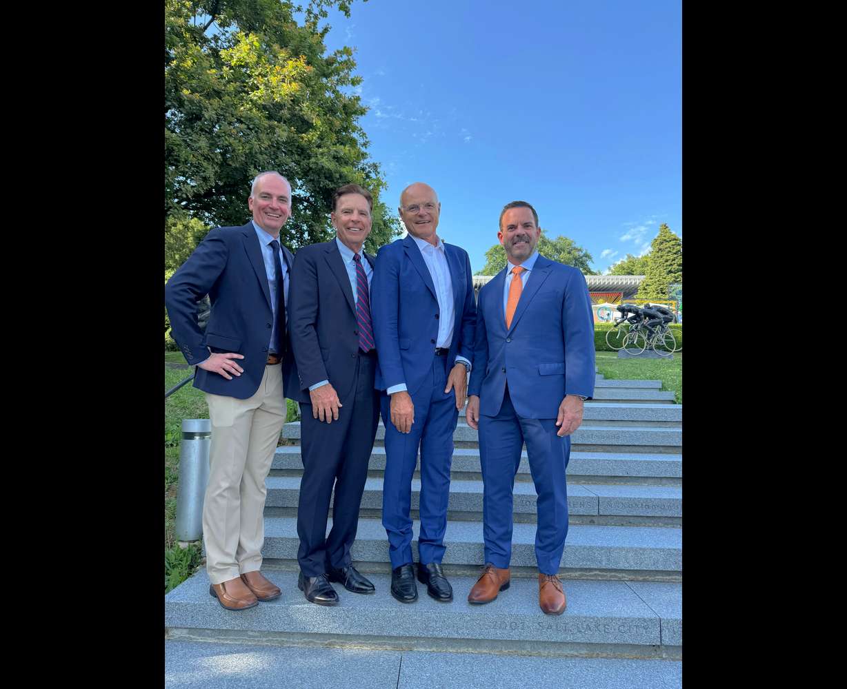 From left, Darren Hughes, vice president of the Utah Organizing Committee for the 2034 Olympic and Paralympic Winter Games, Fraser Bullock, president and executive chair of the Utah Organizing Committee for the 2034 Olympic and Paralympic Winter Games, Karl Stoss, an International Olympic Committee member from Austria who was chair of the IOC Future Host Commission that evaluated Utah’s Olympic bid, and Brad Wilson, CEO of the Utah Organizing Committee for the 2034 Olympic and Paralympic Winter Games, on the steps of the Olympic Museum in Lausanne, Switzerland. An inscription for the 2001 Games in Salt Lake City can be seen near Wilson's feet.