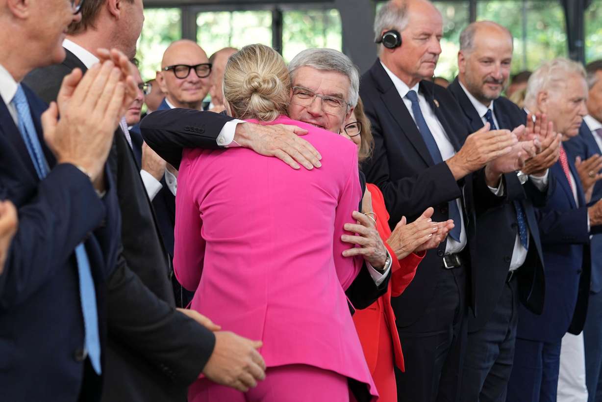 The outgoing IOC President Thomas Bach hugs the new IOC President Kirsty Coventry during the handover ceremony of the IOC Presidency at Olympic House in Lausanne, Switzerland, Monday.