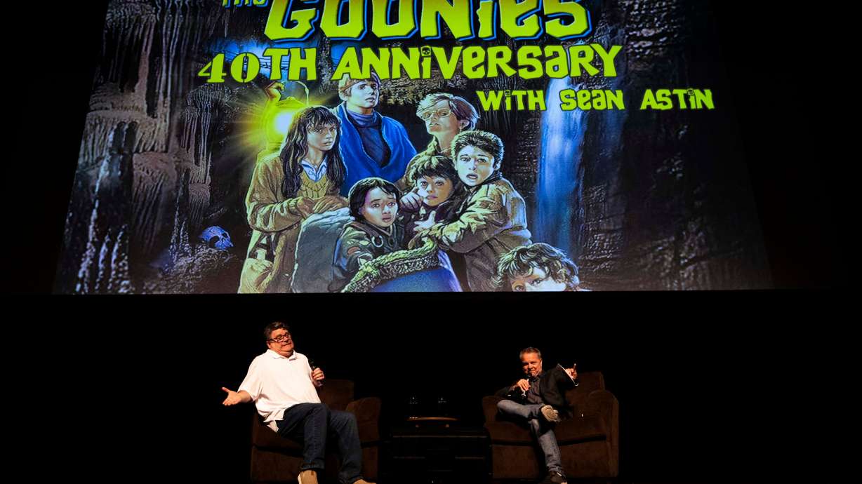 Sean Astin, left, and Andrew Lenz, right, talk with each other during a moderated discussion following a 40th anniversary screening of "The Goonies" at Kingsbury Hall on the campus of the University of Utah in Salt Lake City on Saturday.