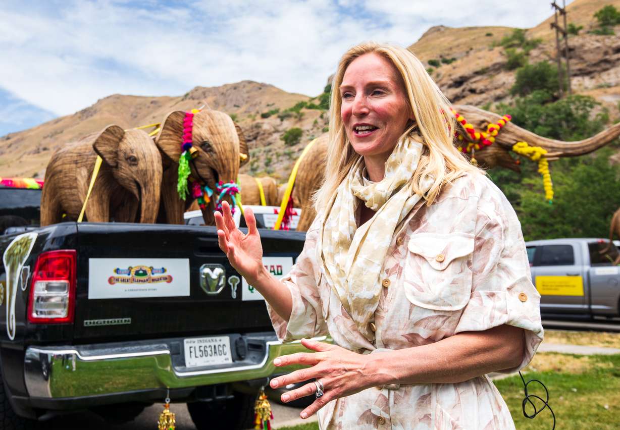 Ruth Ganesh, co-founder of the Great Elephant Migration, speaks to reporters in front of a few of the elephant sculptures at Warm Springs Park in Salt Lake City on Monday.