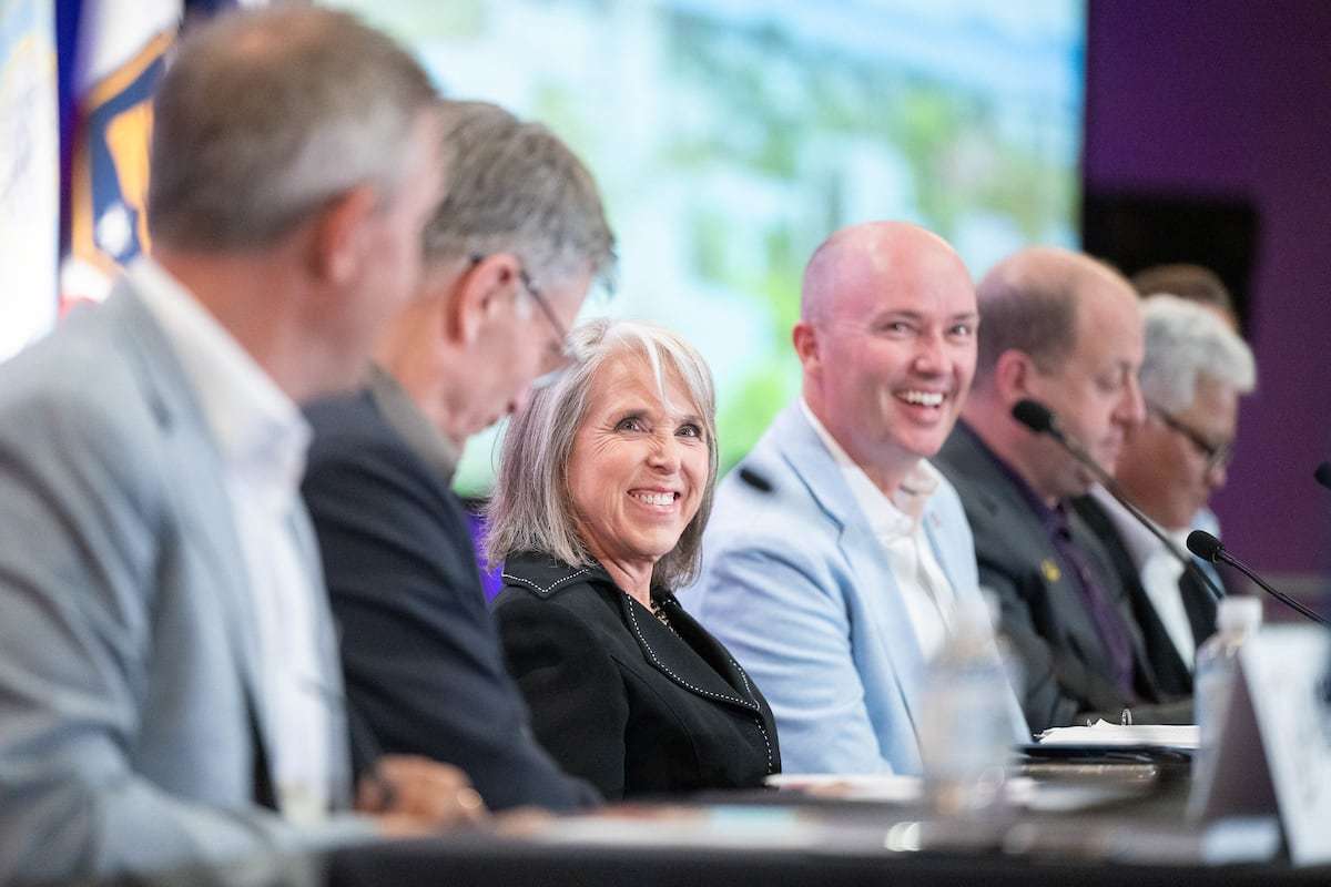New Mexico Gov. Michelle Lujan Grisham, chair of Western Governors Association, talks beside Utah Gov. Spencer Cox, vice chairman of association, during a meeting of the Western Governors Association in Santa Fe, N.M., on Monday.