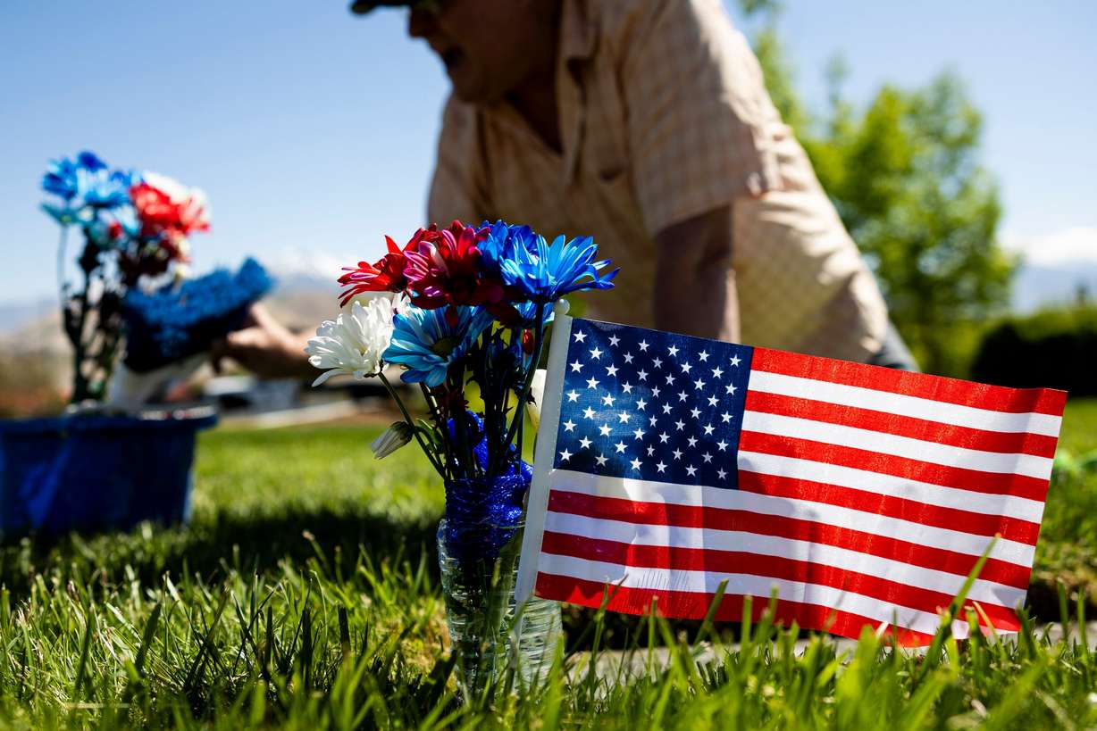 Daniel Luke, of Kaysville, tends to the grave of his father-in-law, Charles Gordon Neerings, at the Utah Veterans Cemetery and Memorial Park in Bluffdale, May 21. Neerings served in the U.S. Merchant Marines, Coast Guard and Army.