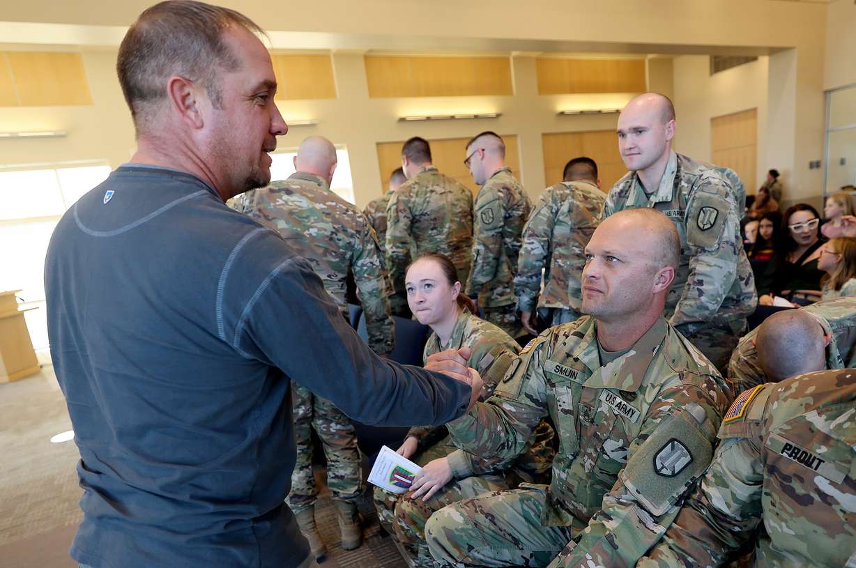 Command Sgt. Maj. Richard Thalman shakes hands with Sgt. 1st Class Jeremy Smuin during a farewell ceremony for the Utah Army National Guard's 115th Engineer Facility Detachment, 204th Maneuver Enhancement Brigade, at the Sunrise Hall Chapel at Camp Williams on Nov. 28, 2023. Smuin and the brigade are deploying to Kuwait to support base facilities for Operation Spartan Shield.