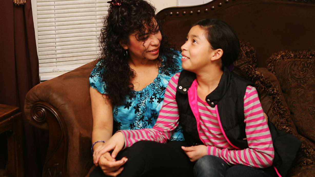 Hilda Echeveria talks with her 10-year-old daughter, Deborah, during a family Parents Empowered meeting at her home in Clinton on Jan. 14, 2013. Parents Empowered is a program that educates parents on how to prevent alcohol use among youth.