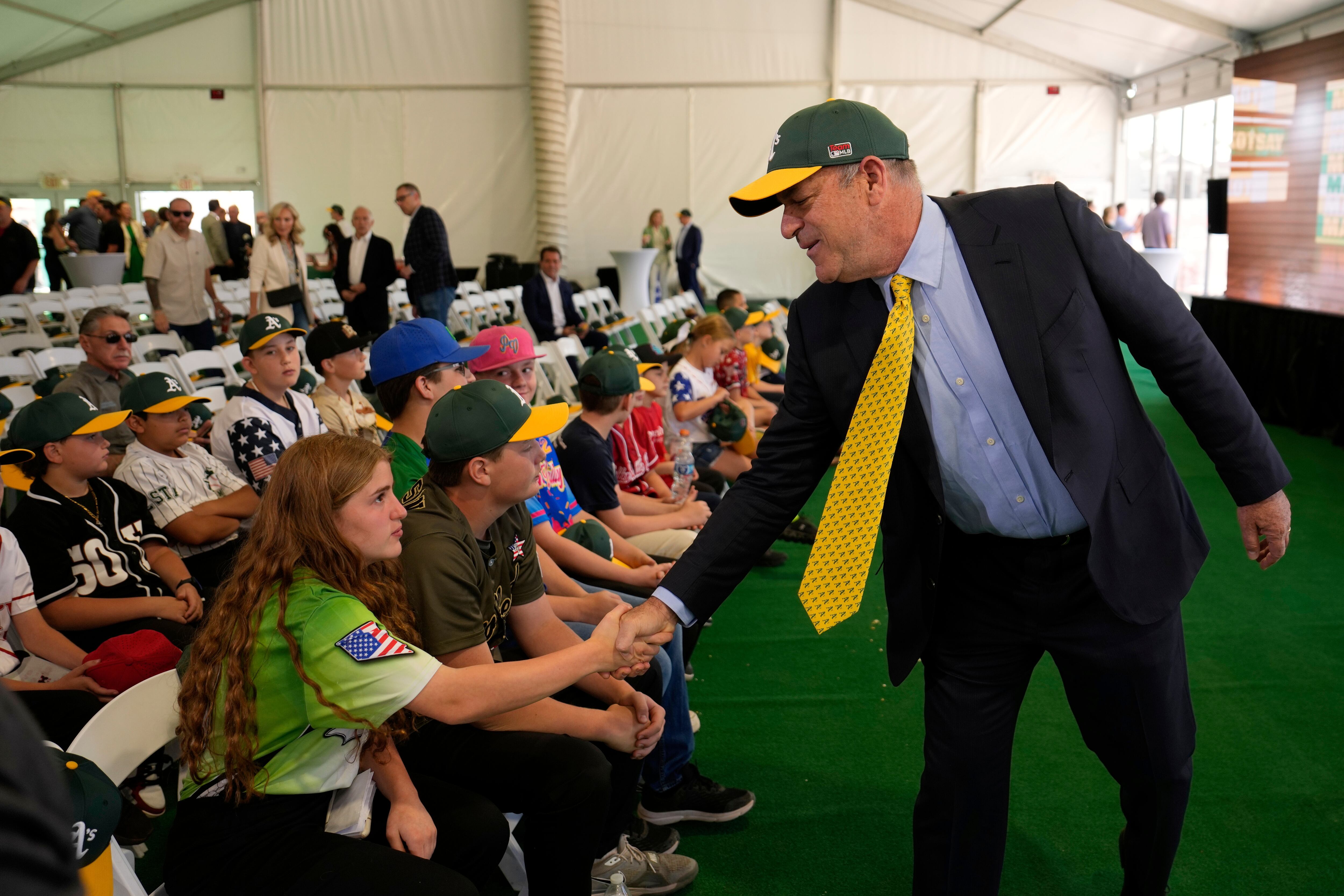 Athletics owner John Fisher meets with people during a groundbreaking ceremony for the Athletics' baseball stadium Monday, in Las Vegas. Questions continue to circulate about the future possible expansion of baseball.