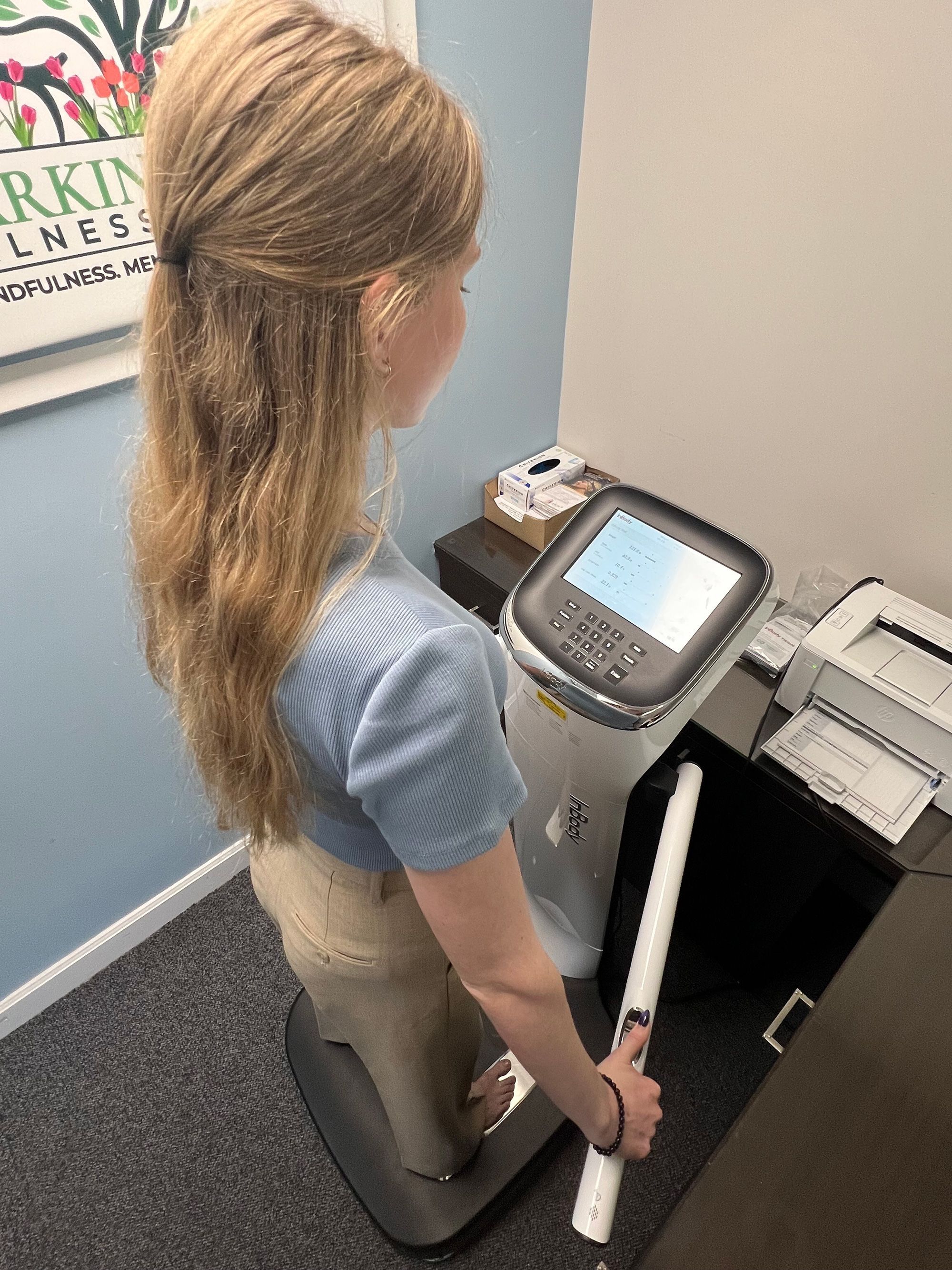 A mild electric current is sent through the body via the feet and thumbs on this bioelectrical impedance analysis machine. Authors of a new study say BIA may be a more accurate method of weight measurement.