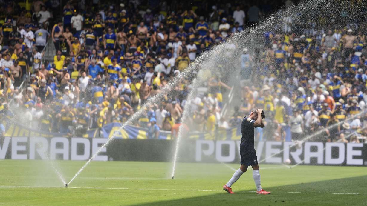Auckland City's Gerard Garriga cools off under the sprinklers during a water break in the Club World Cup Group C soccer match between Auckland City and Boca Juniors in Nashville, Tenn., Tuesday, June 24, 2025.