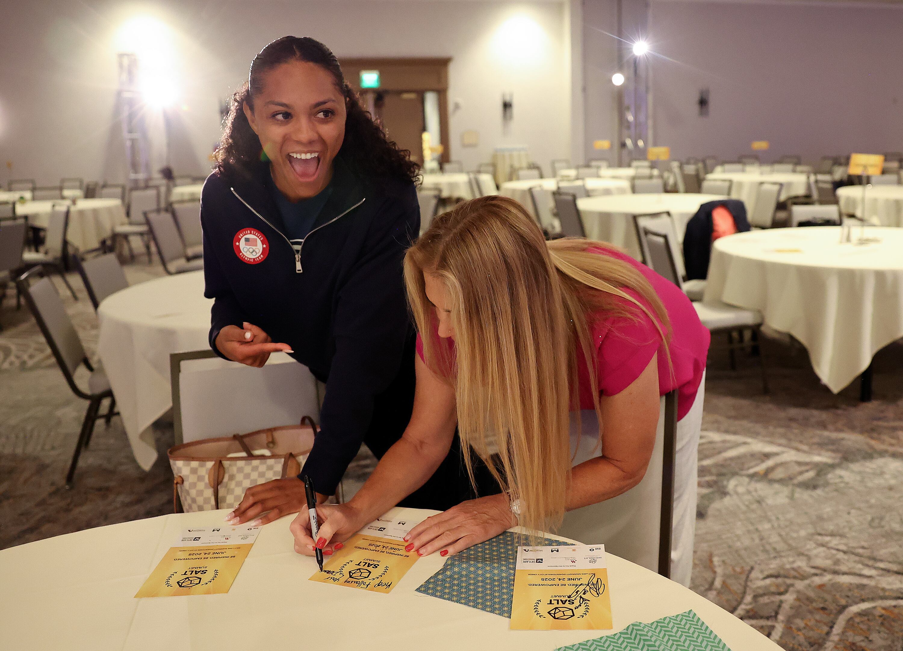Olympic bobsledder Kaysha Love as Olympic skier Picabo Street signs an autograph for her at SALT Summit at the Salt Lake Marriott Downtown at City Creek in Salt Lake City on Tuesday. The two athletes were keynote speakers.