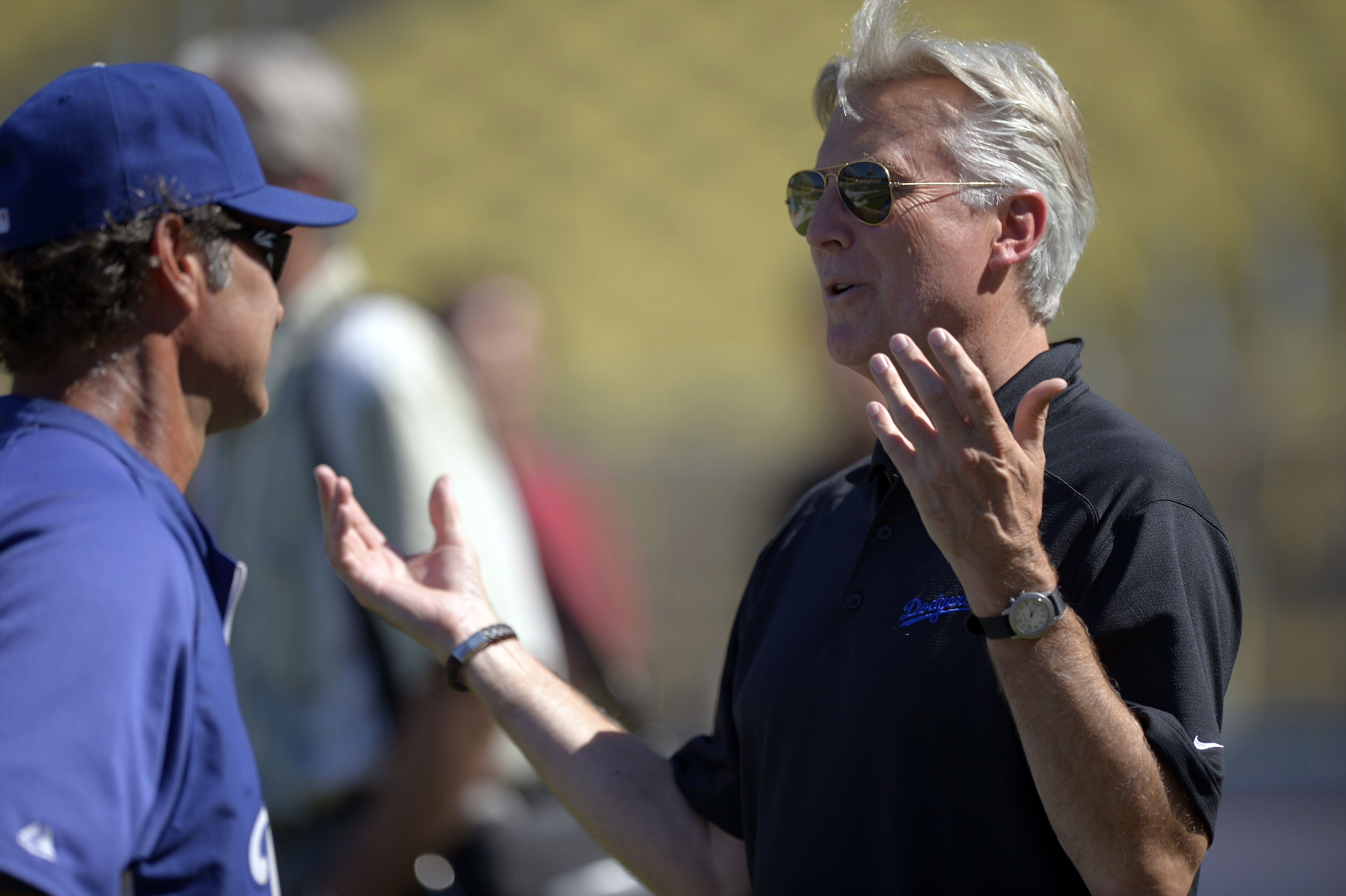FILE - Los Angeles Dodgers co-owner Mark Walter, right, talks with manager Don Mattingly prior to their baseball game against the San Diego Padres, Sept. 3, 2012, in Los Angeles. 