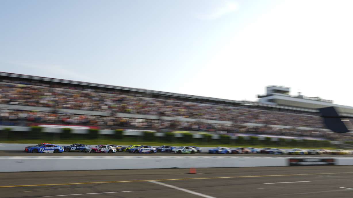 Chase Briscoe (19) and Denny Hamlin (11) lead the field on a restart during a NASCAR Cup Series auto race at Pocono Raceway, Sunday, June 22, 2025, in Long Pond, Pa.