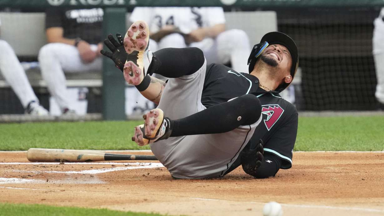 Arizona Diamondbacks' Ildemaro Vargas reacts after hit by pitch from Chicago White Sox relief pitcher Mike Vasil during the second inning of a baseball game in Chicago, Tuesday, June 24, 2025.