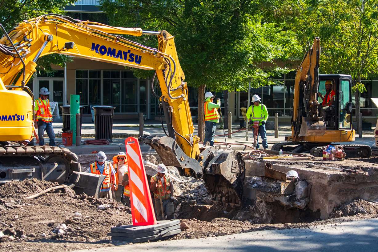 Construction crews work to repair infrastructure underneath 2100 South near 1100 East on June 25. The project to repair the street was among the last pieces of a massive road project bond residents passed in 2018.