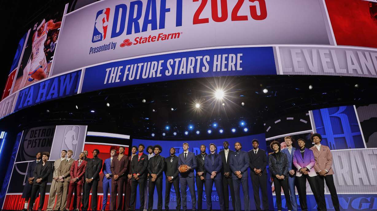 Prospective draft picks gather on stage for a photo before the first round of the NBA basketball draft, Wednesday, June 25, 2025, in New York.