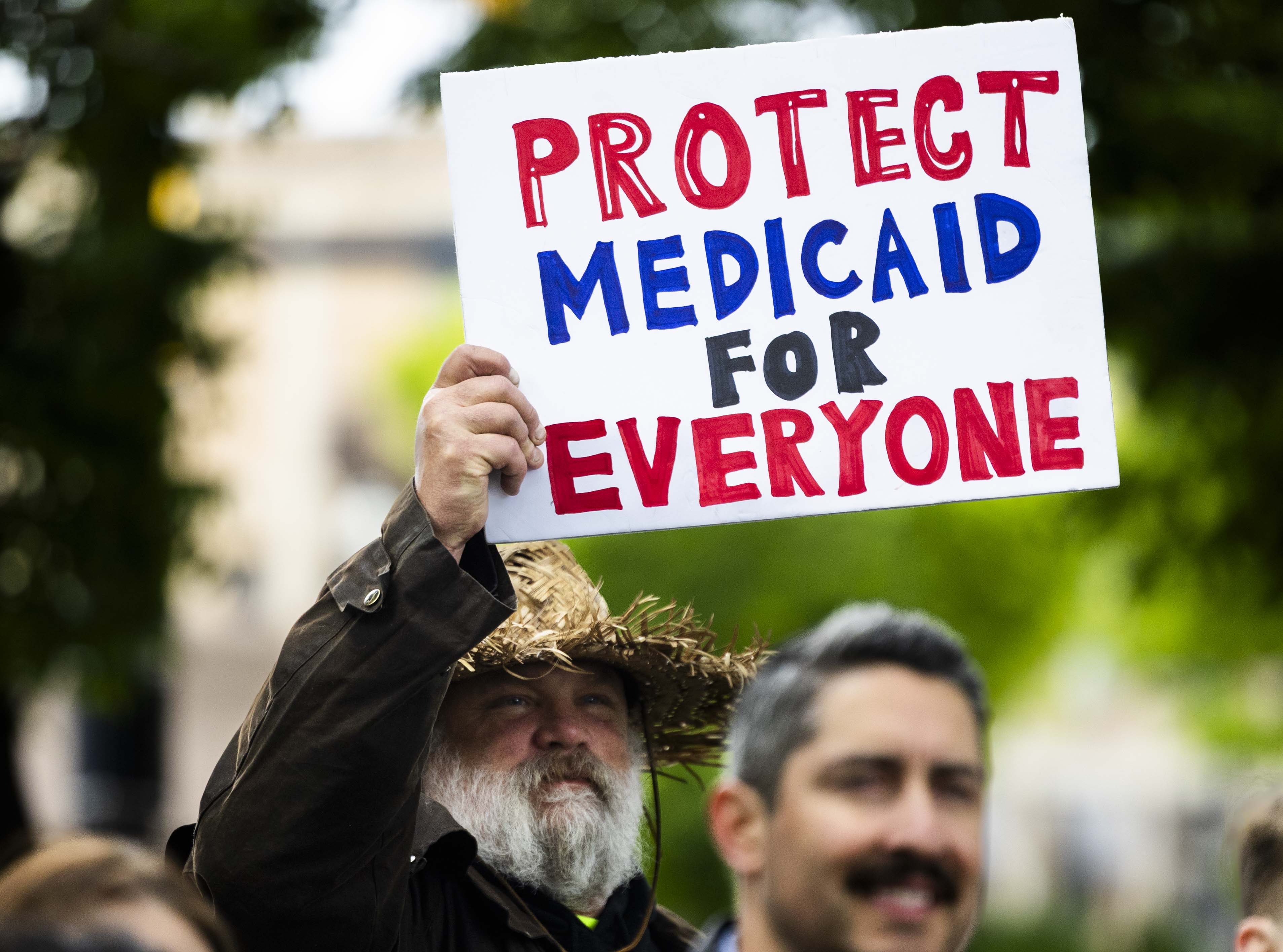 Daniel Crouch holds a sign urging people to protect Medicaid during a press conference in Salt Lake City on May 6. A doctor from Utah joined 4,000 others with a letter to Congress warning that potential cuts to Medicaid could harm millions.