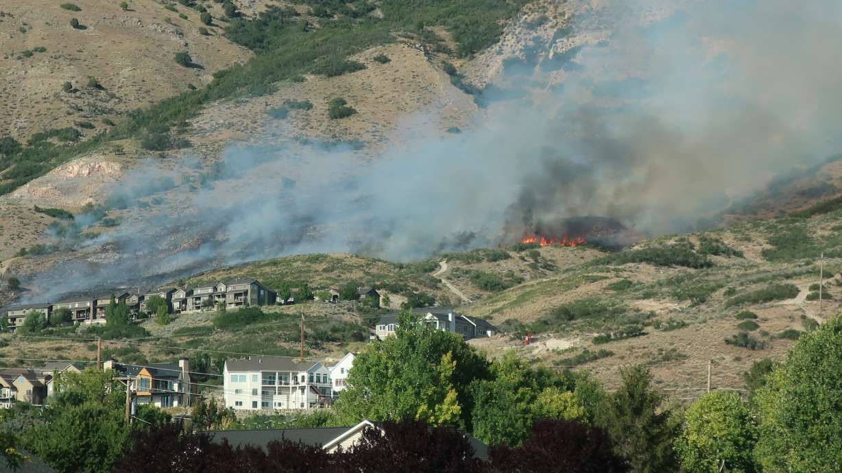 A new wildfire burning Wednesday evening on the hillside near Cedar Hills in Utah County is threatening structures, fire officials said.