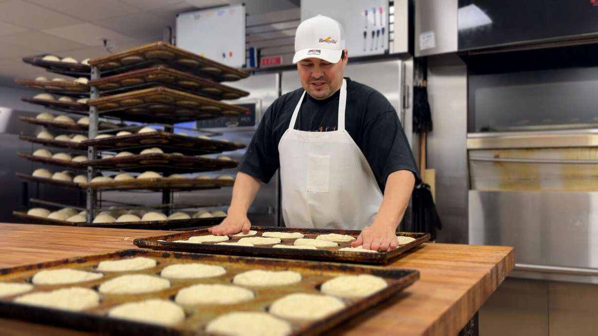 Lance DeRyke prepares hamburger buns that Topper Bakery supplies to Burger Bar restaurants Wednesday. The bakery held its soft reopening after rebuilding from a fire four years ago.