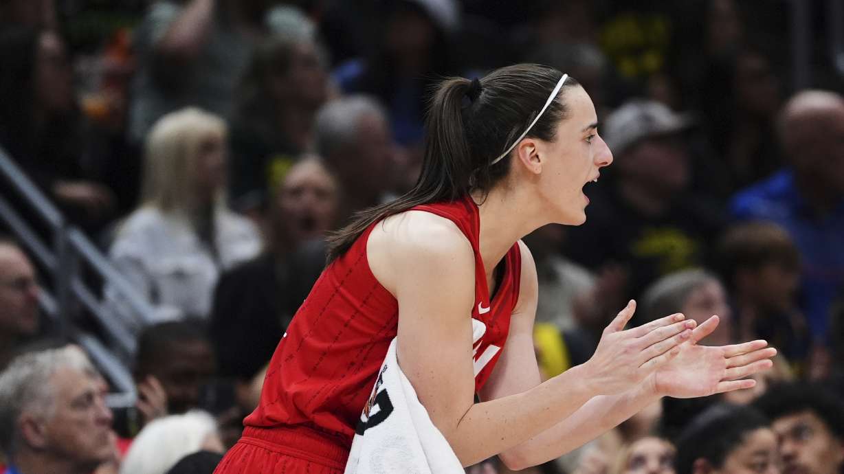 Indiana Fever guard Caitlin Clark claps from the bench during the second half of a WNBA basketball game against the Seattle Storm, Tuesday, June 24, 2025, in Seattle.