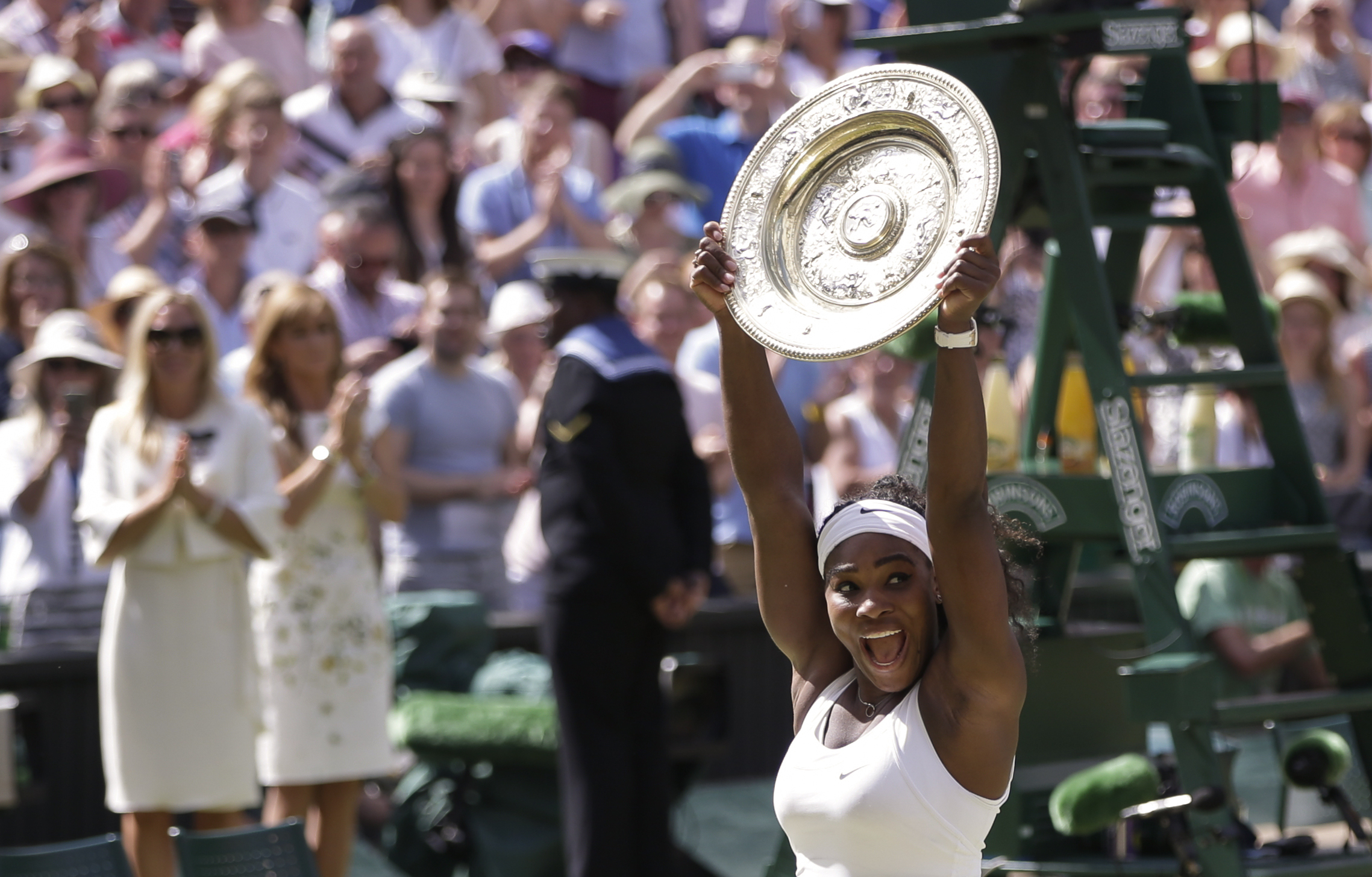 FILE - Serena Williams of the United States reacts as she holds up the trophy after winning the women's singles final against Garbine Muguruza of Spain, at the All England Lawn Tennis Championships in Wimbledon, London, Saturday July 11, 2015. 