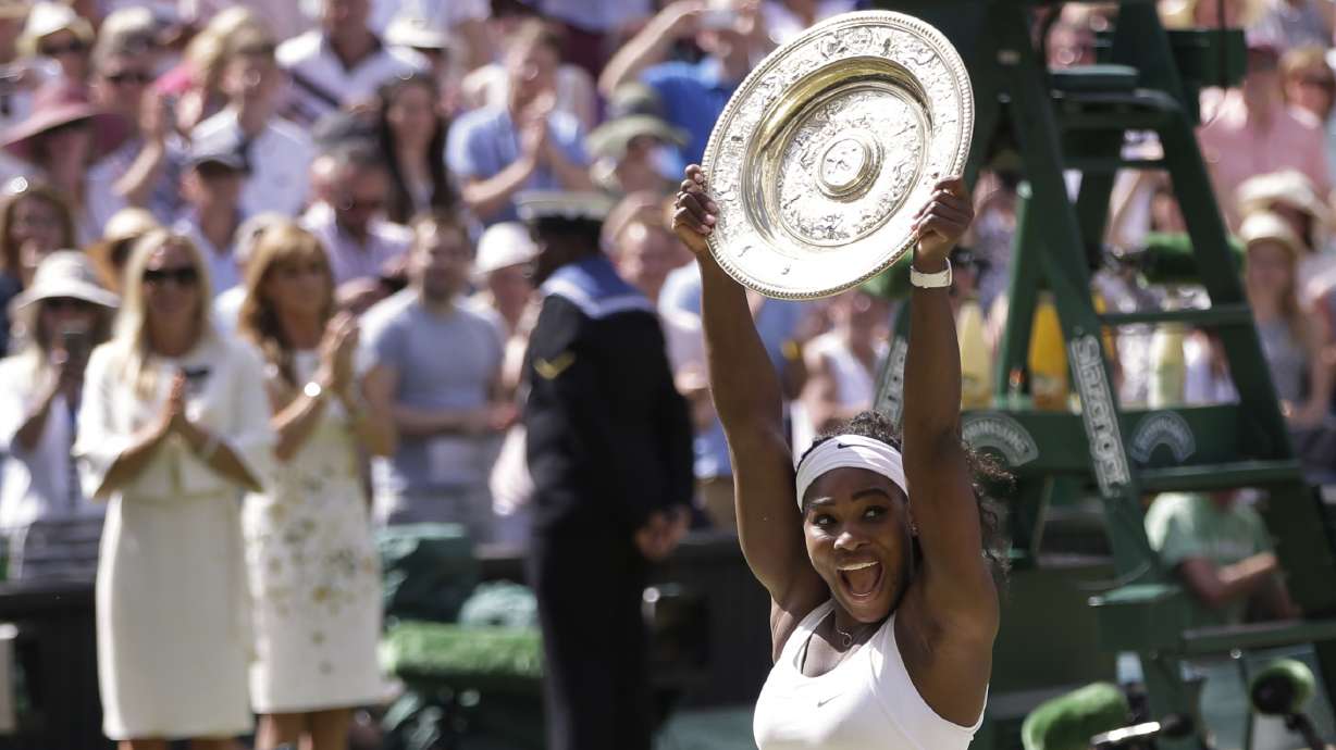 FILE - Serena Williams of the United States reacts as she holds up the trophy after winning the women's singles final against Garbine Muguruza of Spain, at the All England Lawn Tennis Championships in Wimbledon, London, Saturday July 11, 2015.