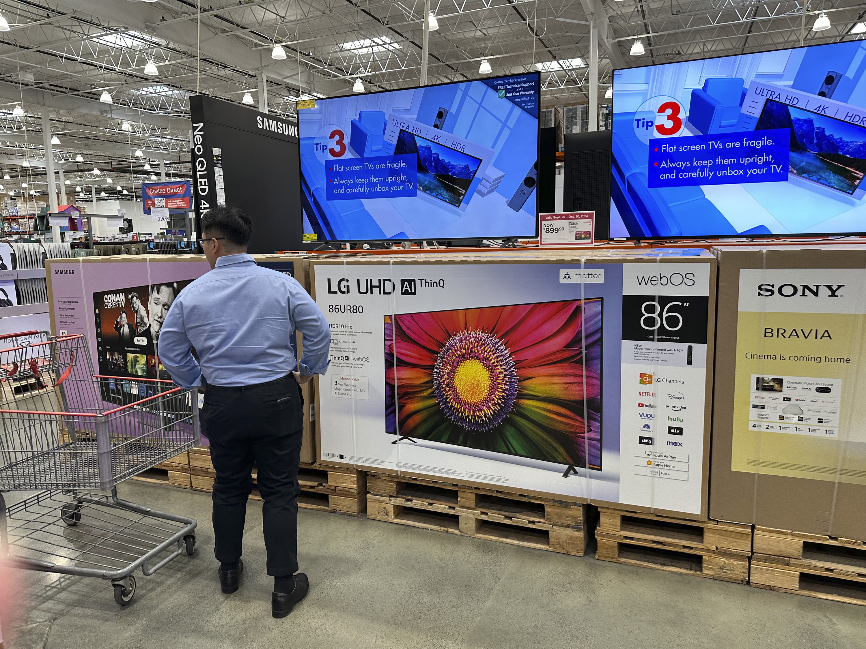 A shopper considers large-screen televisions on display at a Costco warehouse in Timnath, Colorado, on Oct. 3, 2024. A key inflation gauge rose in May, marking the latest sign that prices remain stubbornly elevated.