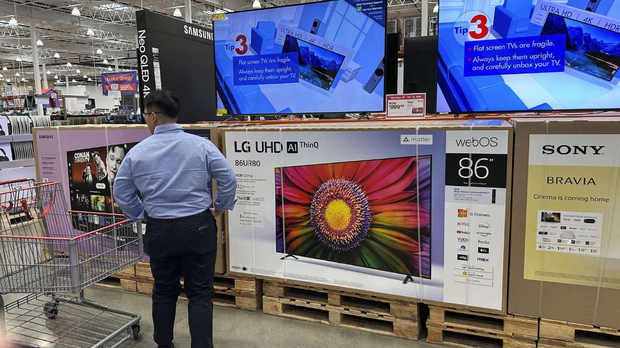 A shopper considers large-screen televisions on display at a Costco warehouse in Timnath, Colorado, on Oct. 3, 2024. A key inflation gauge rose in May, marking the latest sign that prices remain stubbornly elevated.